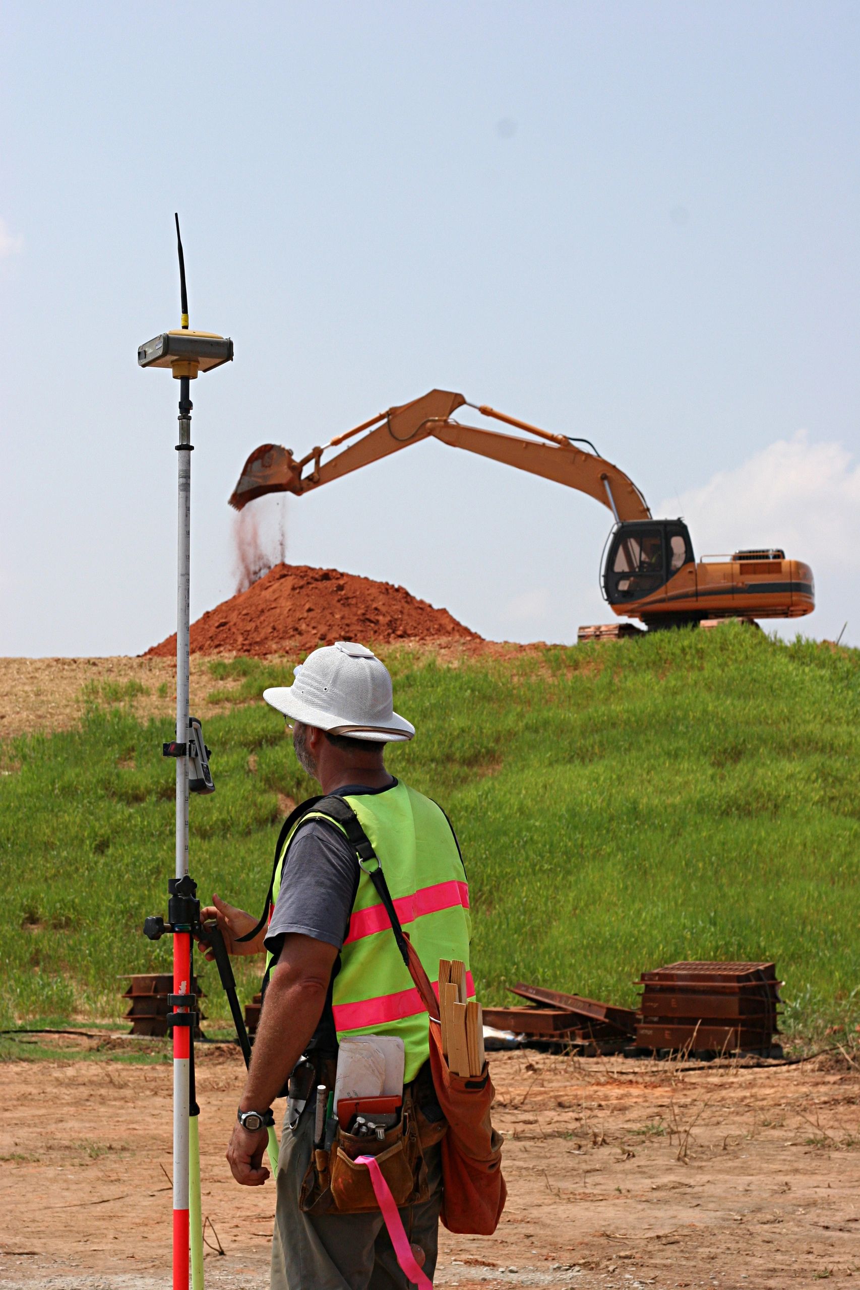 Grading machinery leveling a construction site