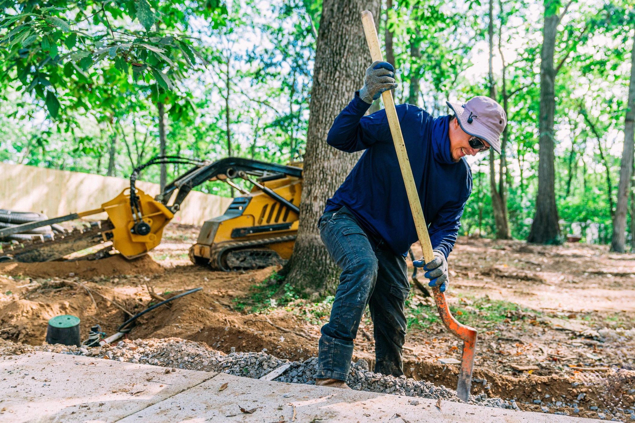 excavator digging trench at construction site