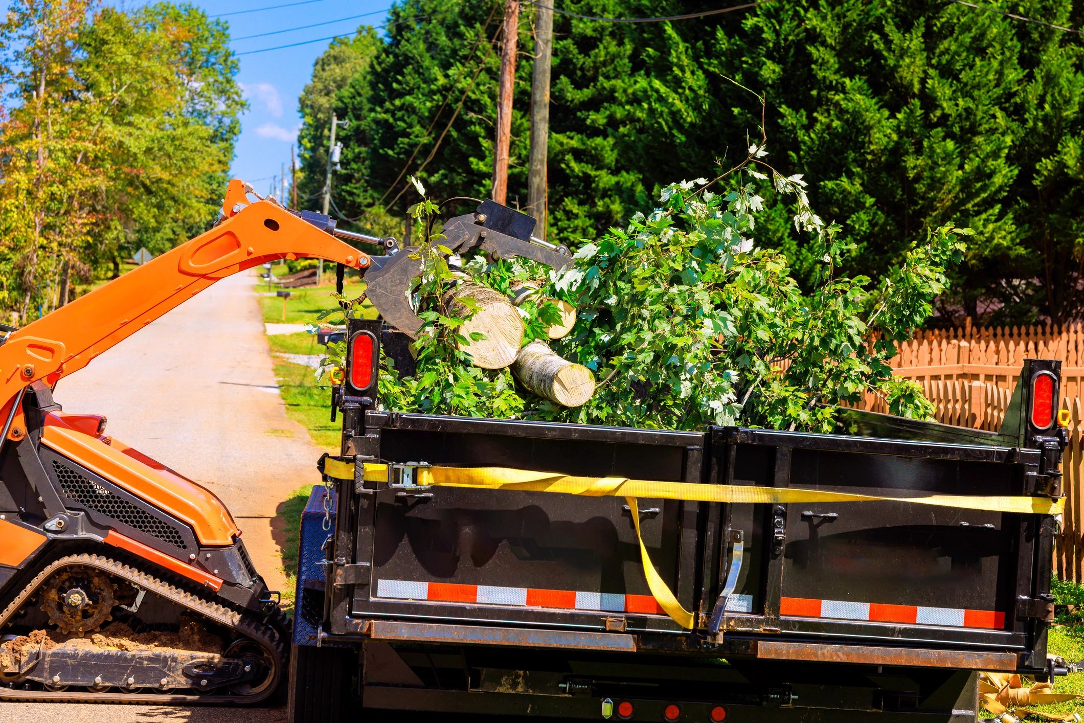 Bulldozer clearing trees and brush from a lot