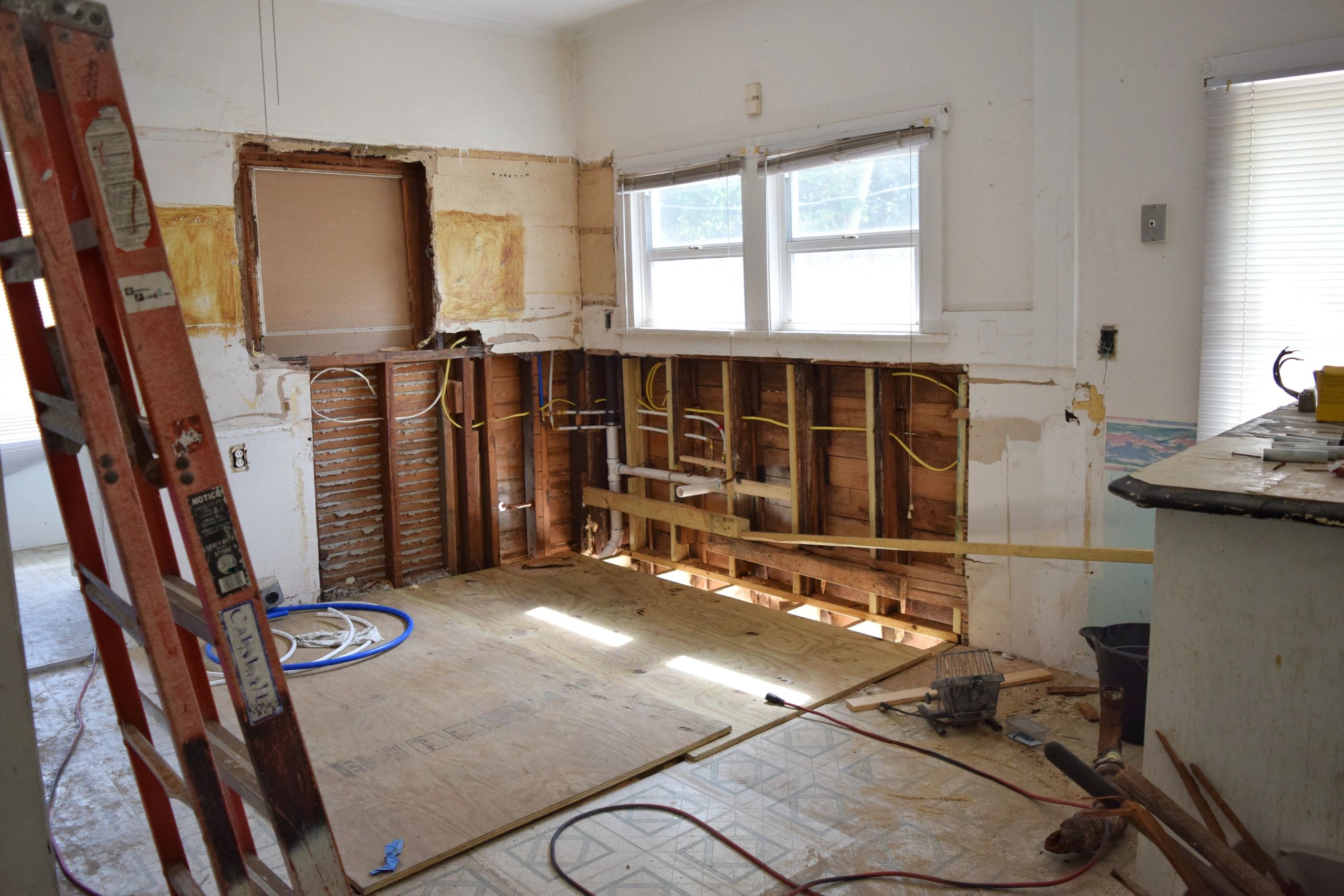 bathroom demolition with tiles and fixtures removed